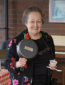 Woman holding casat iron pan