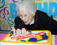 Marge Gull blows out her birthday candle celebrating 100 years.
