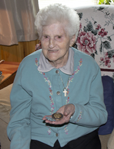 Resident Hallie Dixon shows her challenge coin.